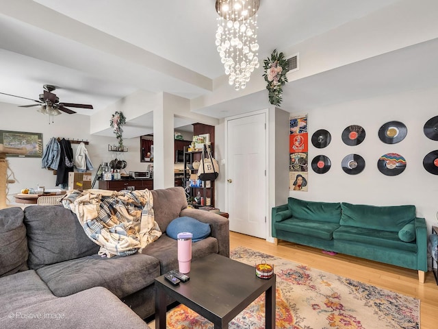 2118 W N Ave Unit Bs, Chicago, IL 60647 - living room with light wood-style flooring, a ceiling fan, and a chandelier