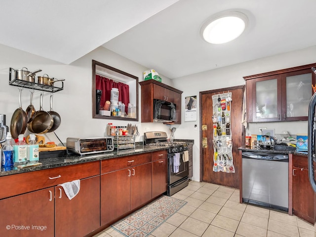 2118 W N Ave Unit Bs, Chicago, IL 60647 - kitchen with dishwasher, gas range, black microwave, light tile patterned flooring, and dark stone counters