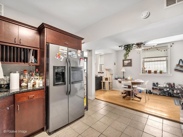 2118 W N Ave Unit Bs, Chicago, IL 60647 - kitchen featuring stainless steel refrigerator with ice dispenser, light tile patterned floors, ceiling fan, and dark stone counters