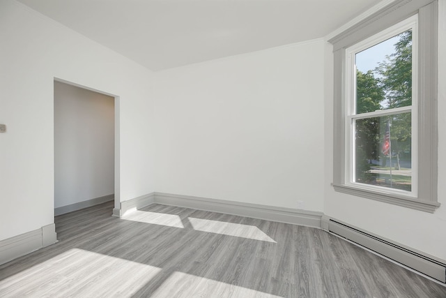 123 N W St, Wheaton, IL 60187 - empty room with a baseboard radiator and light wood-type flooring