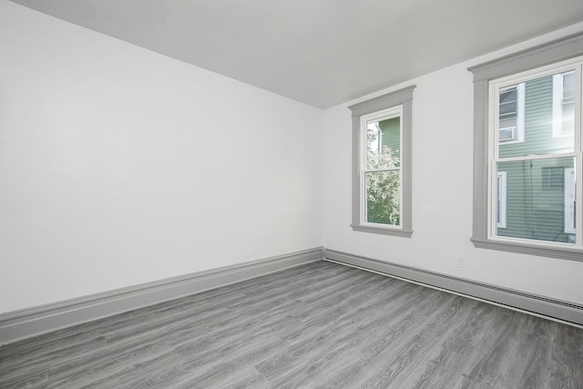 123 N W St, Wheaton, IL 60187 - empty room with wood finished floors and a baseboard heating unit
