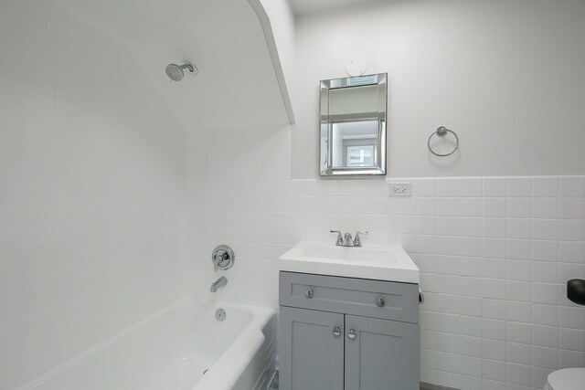 123 N W St, Wheaton, IL 60187 - bathroom featuring tile walls, vanity, and bathing tub / shower combination