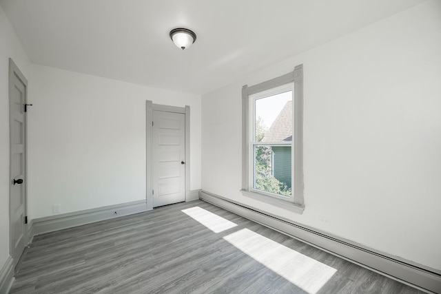 123 N W St, Wheaton, IL 60187 - unfurnished room featuring a baseboard heating unit and wood finished floors