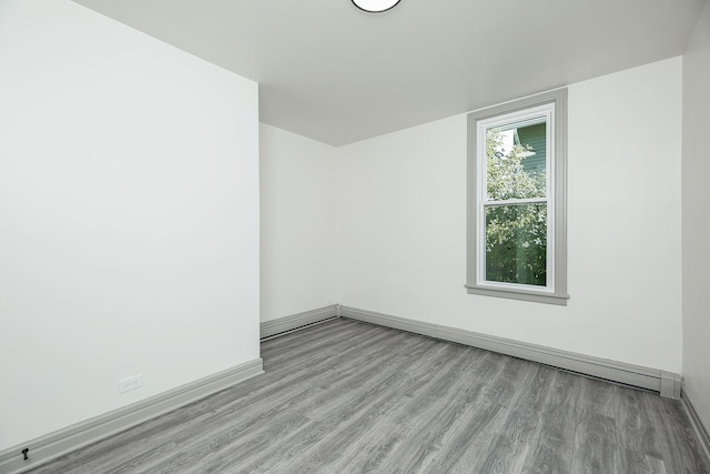 123 N W St, Wheaton, IL 60187 - spare room with wood finished floors and a baseboard radiator