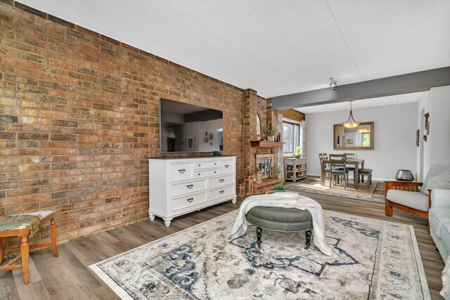 1422 Woodbridge Rd Unit 2E, Joliet, IL 60436 - living room with dark wood-type flooring and brick wall