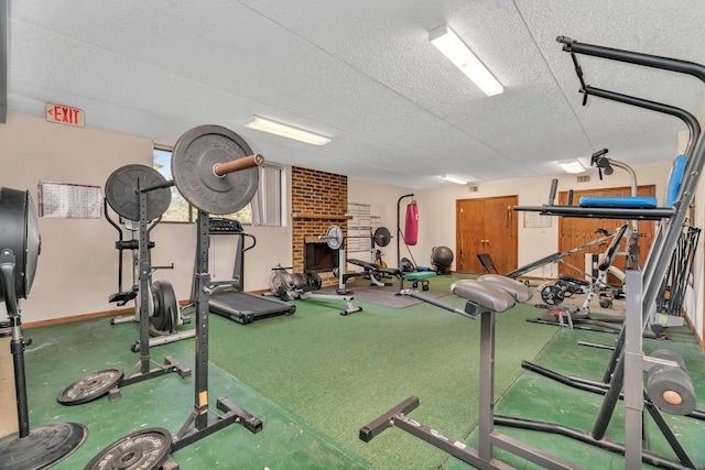 1422 Woodbridge Rd Unit 2E, Joliet, IL 60436 - exercise room featuring a textured ceiling and baseboards