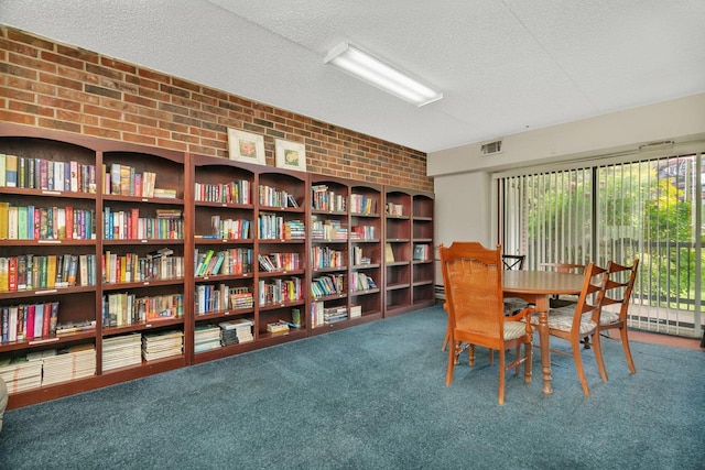 1422 Woodbridge Rd Unit 2E, Joliet, IL 60436 - carpeted dining space featuring brick wall and a textured ceiling