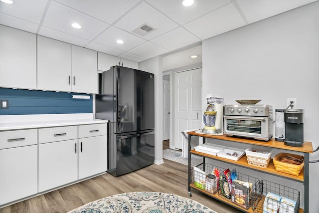 1422 Woodbridge Rd Unit 2E, Joliet, IL 60436 - kitchen featuring freestanding refrigerator, light wood-type flooring, light countertops, white cabinetry, and recessed lighting