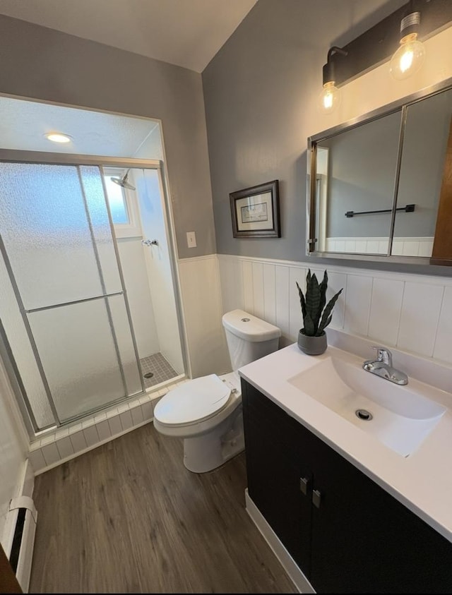 1205 N Harlem Ave Unit 6, Oak Park, IL 60302 - bathroom featuring a stall shower, wood finished floors, vanity, a wainscoted wall, and a baseboard radiator