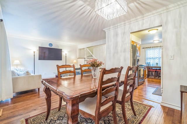 817 Hibbard Rd Unit D, Wilmette, IL 60091 - dining room featuring crown molding, hardwood / wood-style floors, and stairs