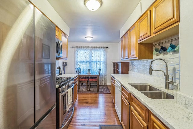 817 Hibbard Rd Unit D, Wilmette, IL 60091 - kitchen with stainless steel appliances, brown cabinetry, dark wood-style flooring, and light stone counters
