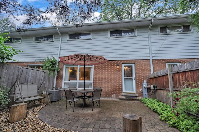 817 Hibbard Rd Unit D, Wilmette, IL 60091 - rear view of house featuring a patio area, a fenced backyard, and brick siding