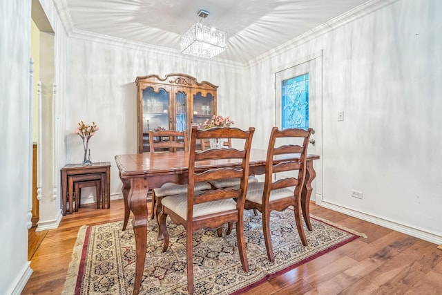 817 Hibbard Rd Unit D, Wilmette, IL 60091 - dining space featuring a chandelier, crown molding, and wood finished floors