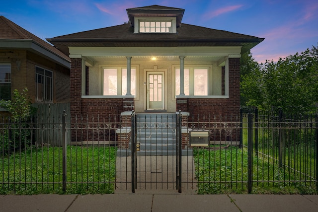 7545 S Ridgeland Ave, Chicago, IL 60649 - view of front of property featuring brick siding, a porch, a fenced front yard, and a gate
