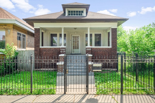 7545 S Ridgeland Ave, Chicago, IL 60649 - view of front of house featuring a porch, brick siding, a fenced front yard, and a gate