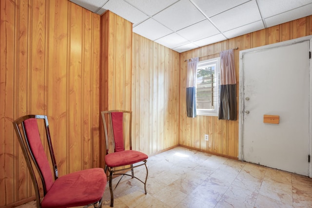 7545 S Ridgeland Ave, Chicago, IL 60649 - living area with wood walls, a drop ceiling, and light flooring