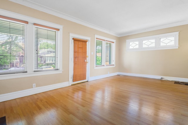 7545 S Ridgeland Ave, Chicago, IL 60649 - unfurnished room featuring plenty of natural light, light wood-type flooring, and ornamental molding