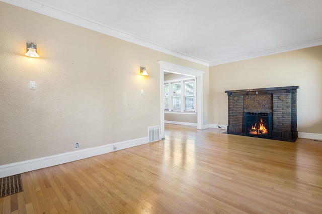 7545 S Ridgeland Ave, Chicago, IL 60649 - unfurnished living room with ornamental molding, a fireplace, and light wood-style floors