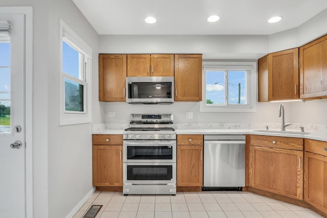 17525 W Walnut Ln, Gurnee, IL 60031 - kitchen with appliances with stainless steel finishes, brown cabinets, light countertops, and healthy amount of natural light
