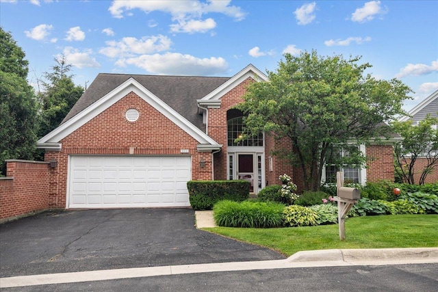 850 Evergreen Way, Highland Park, IL 60035 - view of front facade featuring driveway, brick siding, a garage, and a front yard