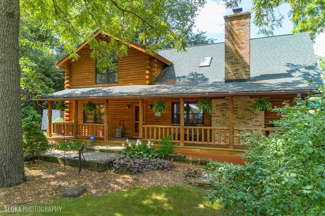 723 N River Rd, Algonquin, IL 60102 - back of property with a porch, log exterior, and a chimney