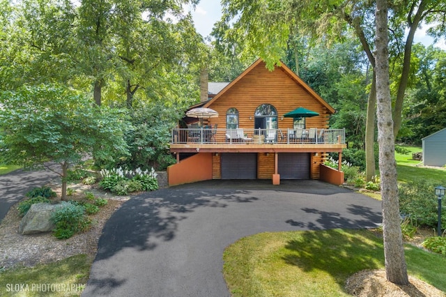 723 N River Rd, Algonquin, IL 60102 - cabin featuring a deck, asphalt driveway, and a garage