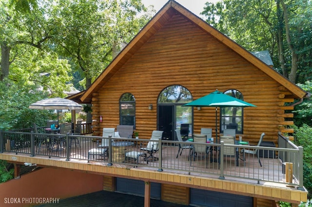 723 N River Rd, Algonquin, IL 60102 - back of house with outdoor dining space, log siding, a wooden deck, and a garage