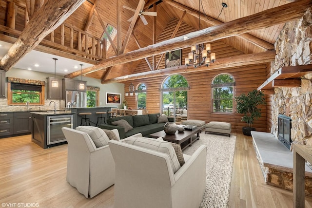 723 N River Rd, Algonquin, IL 60102 - living room with wine cooler, a fireplace, high vaulted ceiling, light wood-style flooring, and plenty of natural light