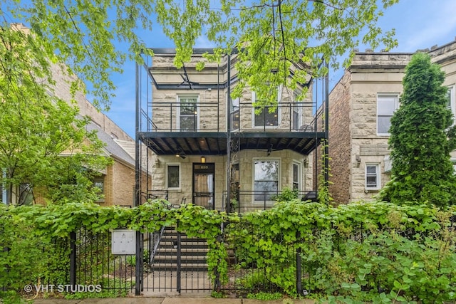 1133 N Spaulding Ave, Chicago, IL 60651 - view of front facade with a balcony, stone siding, and stairway
