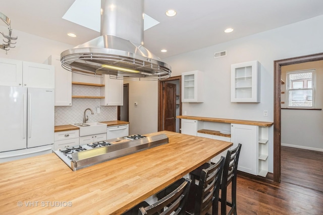 1133 N Spaulding Ave, Chicago, IL 60651 - kitchen with butcher block counters, white appliances, island exhaust hood, open shelves, and recessed lighting