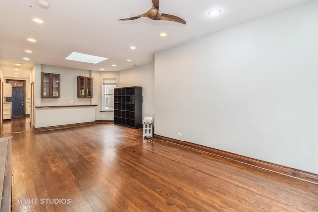 1133 N Spaulding Ave, Chicago, IL 60651 - unfurnished living room featuring a skylight, wood finished floors, ceiling fan, and recessed lighting