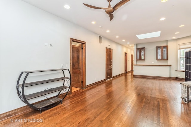 1133 N Spaulding Ave, Chicago, IL 60651 - unfurnished living room featuring a skylight, wood finished floors, ceiling fan, and recessed lighting