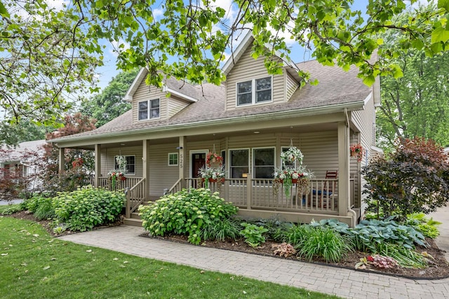 525 Palmer Ave, Aurora, IL 60506 - view of front of home featuring covered porch, a shingled roof, and a front lawn