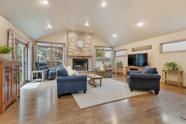 525 Palmer Ave, Aurora, IL 60506 - living area featuring lofted ceiling, plenty of natural light, a stone fireplace, wood finished floors, and recessed lighting