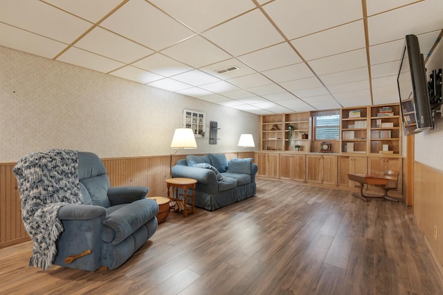 525 Palmer Ave, Aurora, IL 60506 - sitting room with a wainscoted wall, wood finished floors, built in features, a drop ceiling, and wooden walls