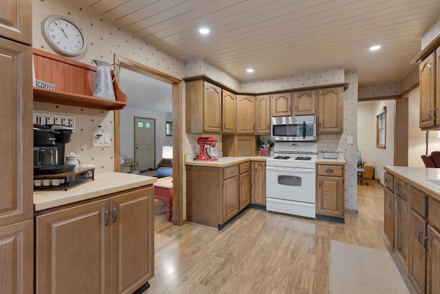 525 Palmer Ave, Aurora, IL 60506 - kitchen with stainless steel microwave, white range, light countertops, light wood-type flooring, and wood ceiling