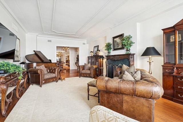 219 E Lake Shore Dr Unit 8C, Chicago, IL 60611 - living area with light wood finished floors, a chandelier, ornamental molding, and a fireplace