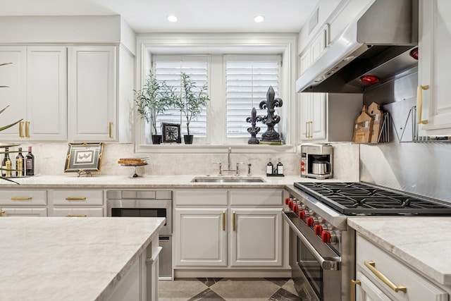 219 E Lake Shore Dr Unit 8C, Chicago, IL 60611 - kitchen featuring high end stainless steel range, ventilation hood, white cabinetry, decorative backsplash, and recessed lighting