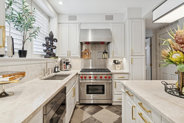 219 E Lake Shore Dr Unit 8C, Chicago, IL 60611 - kitchen with stainless steel appliances, wall chimney range hood, decorative backsplash, white cabinetry, and recessed lighting