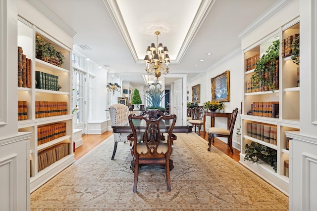 219 E Lake Shore Dr Unit 8C, Chicago, IL 60611 - dining room with a chandelier, crown molding, wood finished floors, and a raised ceiling