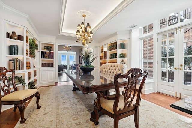 219 E Lake Shore Dr Unit 8C, Chicago, IL 60611 - dining room featuring a chandelier, french doors, crown molding, wood finished floors, and a tray ceiling