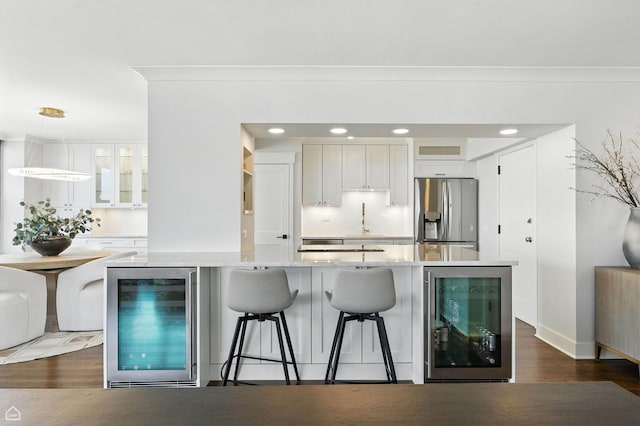 3150 N Lake Shore Dr Unit 29F, Chicago, IL 60657 - kitchen featuring wine cooler, stainless steel fridge, white cabinets, glass insert cabinets, and recessed lighting