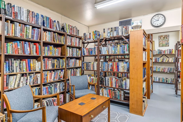 3150 N Lake Shore Dr Unit 29F, Chicago, IL 60657 - sitting room with bookshelves and concrete floors