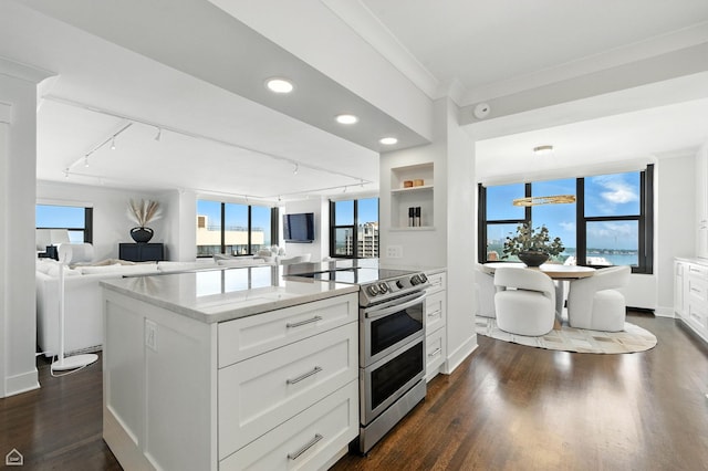 3150 N Lake Shore Dr Unit 29F, Chicago, IL 60657 - kitchen with range with two ovens, rail lighting, dark wood-style floors, white cabinetry, and ornamental molding