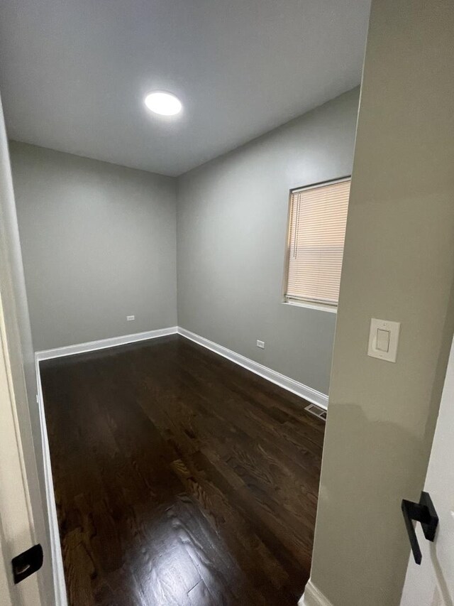 6239 S Bishop St, Chicago, IL 60636 - spare room featuring dark wood finished floors and baseboards