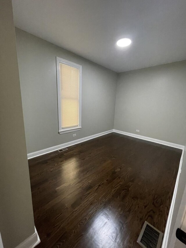 6239 S Bishop St, Chicago, IL 60636 - spare room with baseboards and dark wood-type flooring