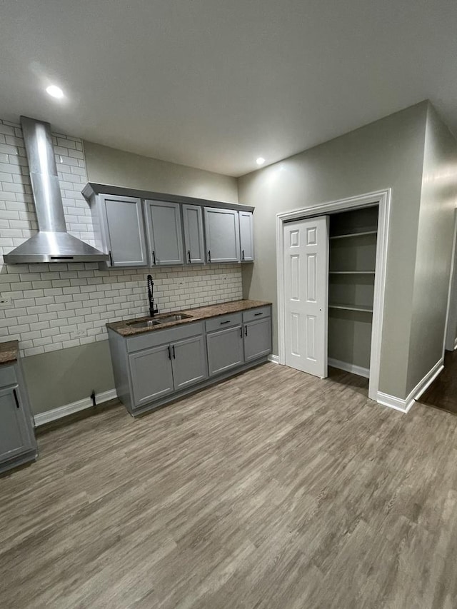 6239 S Bishop St, Chicago, IL 60636 - kitchen featuring wall chimney range hood, gray cabinets, decorative backsplash, light wood-style flooring, and recessed lighting