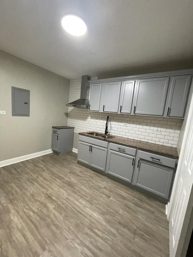 6239 S Bishop St, Chicago, IL 60636 - kitchen with wall chimney range hood, electric panel, gray cabinetry, and decorative backsplash
