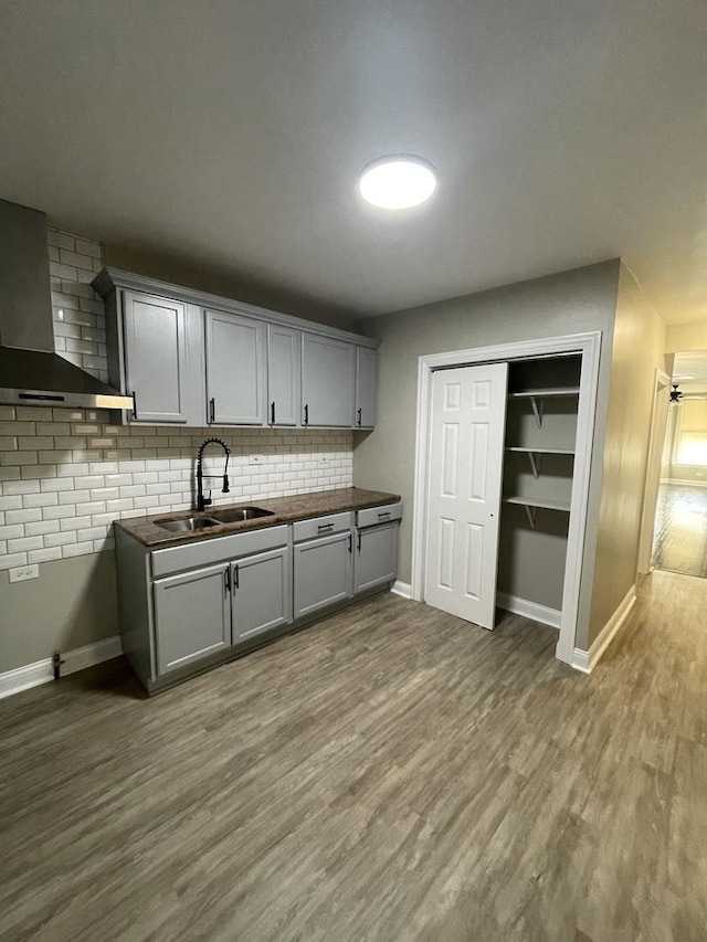 6239 S Bishop St, Chicago, IL 60636 - kitchen featuring wall chimney range hood, backsplash, dark wood finished floors, and gray cabinetry