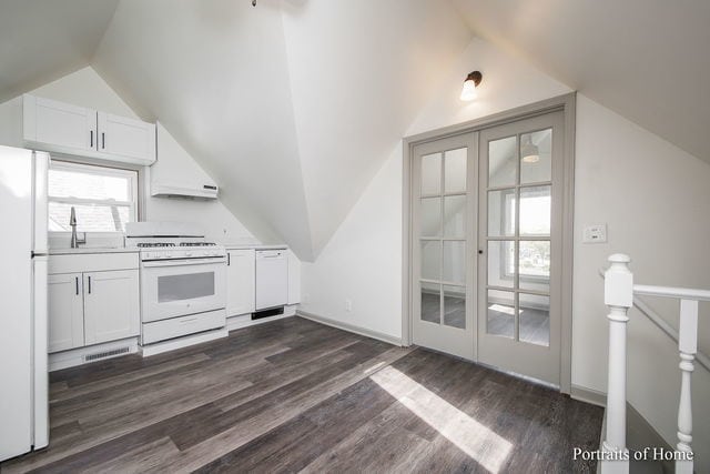 127 N W St, Wheaton, IL 60187 - kitchen featuring white appliances, lofted ceiling, dark wood-style flooring, white cabinets, and light countertops